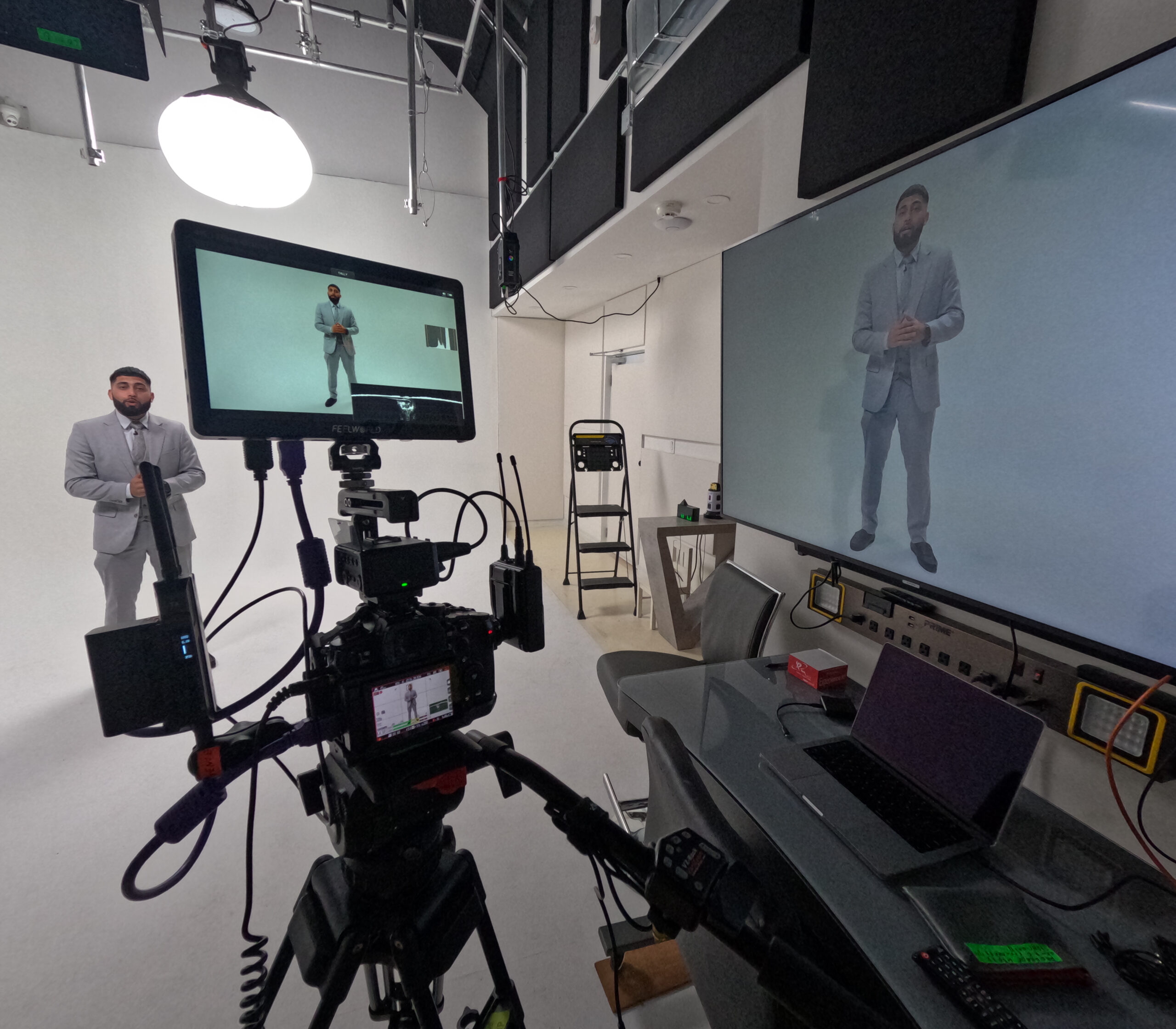 Video Production Services Markham of corporate sales video recording with white cyc wall.